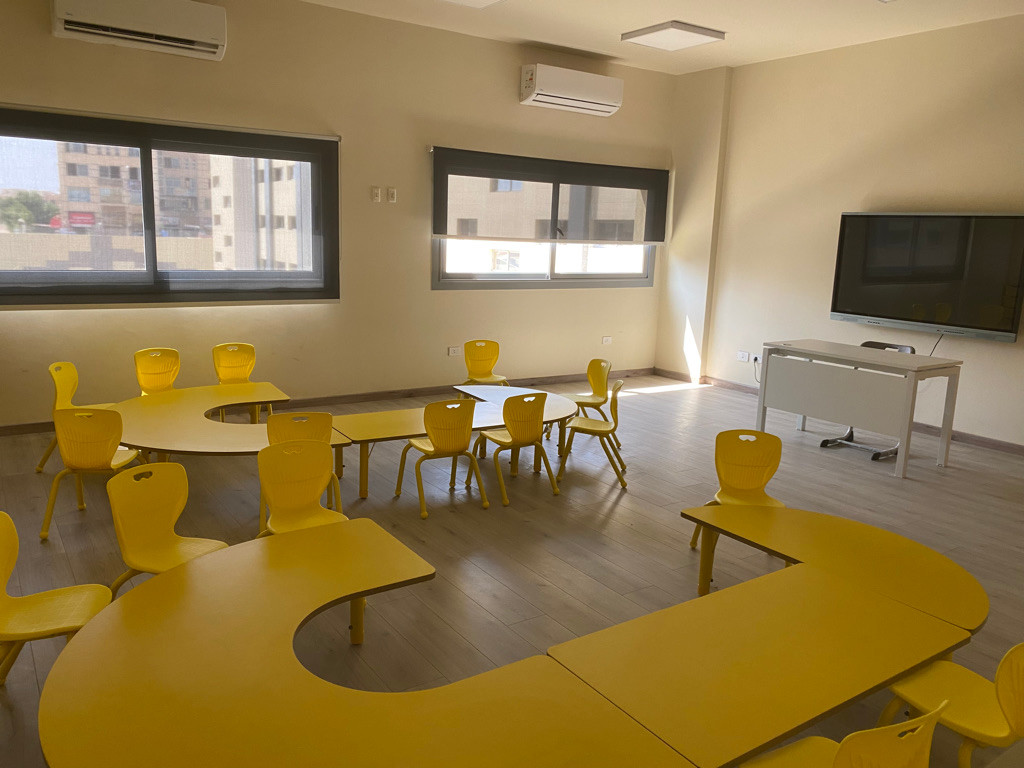 An ESE classroom with yellow learning furniture