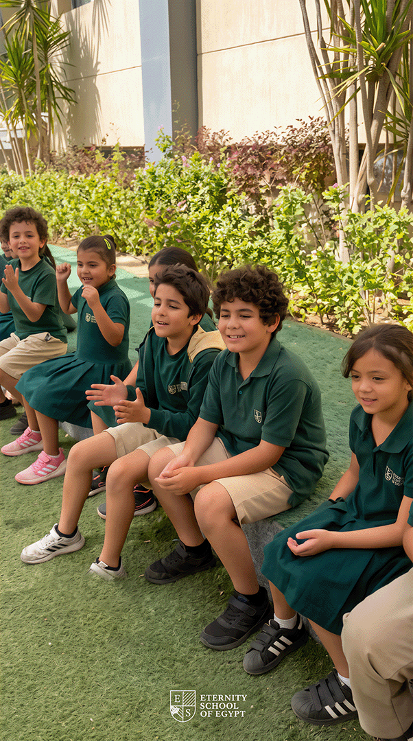 Students seated together and applauding outdoors