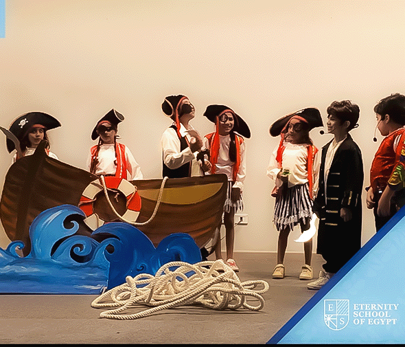 Students performing together on a school stage with pirate costumes and scenery