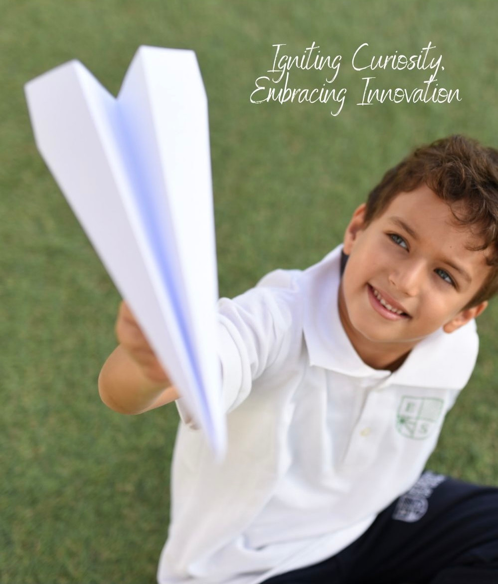 An Eternity School of Egypt student holding a large paper airplane