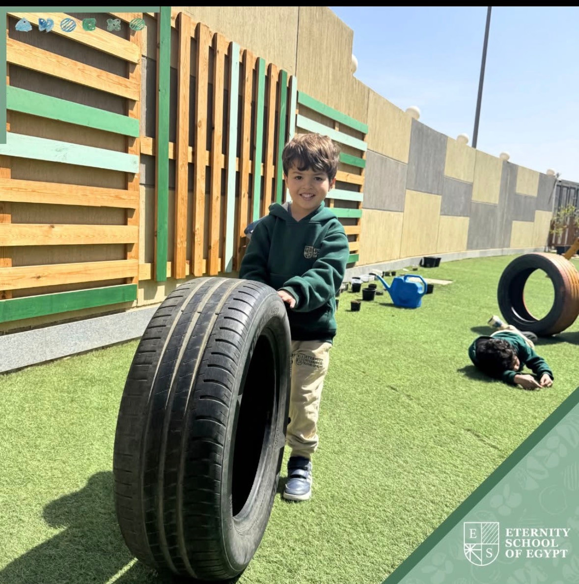 An Eternity School of Egypt student exploring through outdoor tire play